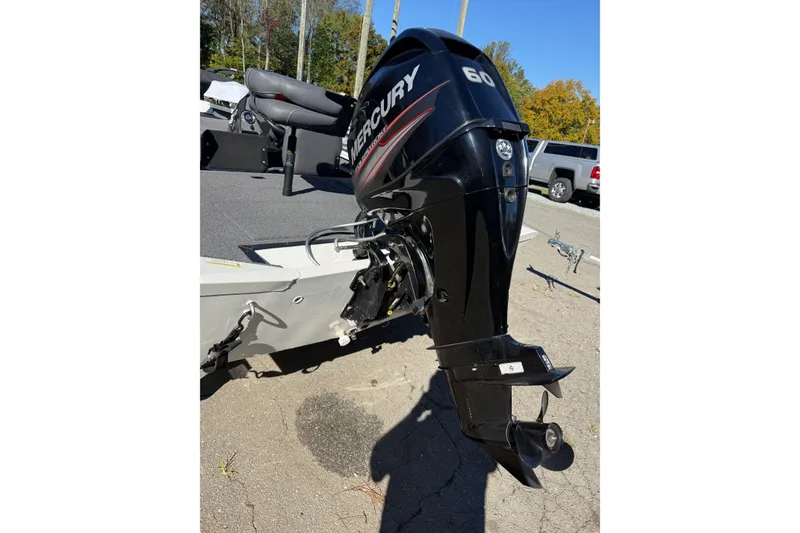 Slide: The Image of 2018 Lowe Stinger 175C boat with Mercury 60 outboard motor in a parking lot. - 20