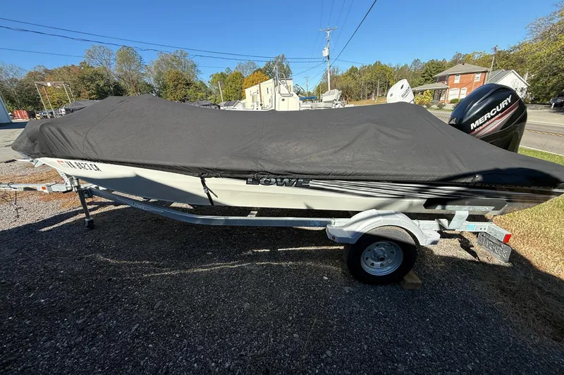 Slide: The Image of 2018 Lowe Stinger 175C boat with cover on trailer, parked outdoors. - 6