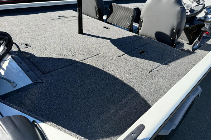 Slide: The Image of 2018 Lowe Stinger 175C boat interior with carpeted deck and seating. - 8