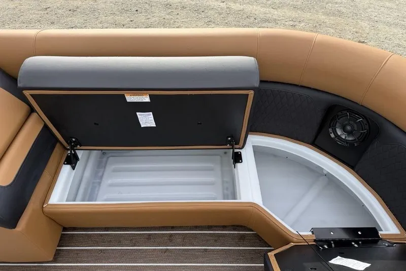 Slide: The Image of Open storage compartment on 2026 Premier 230 Sunsation boat with cushioned seating. - 10