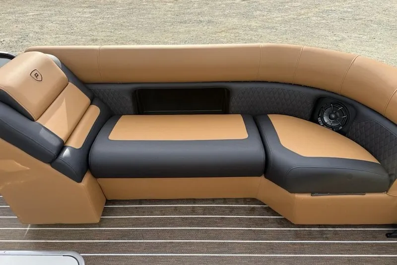 Slide: The Image of Luxurious seating on 2026 Premier 230 Sunsation pontoon boat, featuring tan and black upholstery. - 11