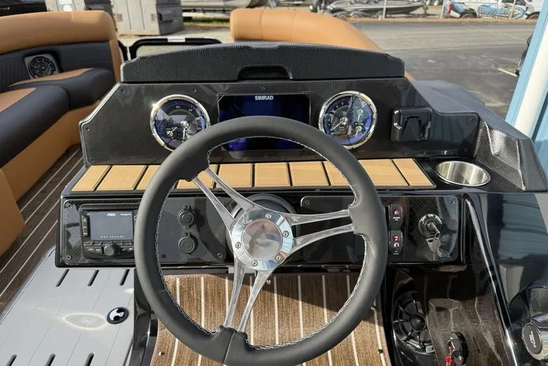 Slide: The Image of 2026 Premier 230 Sunsation boat dashboard with steering wheel and control panel. - 14