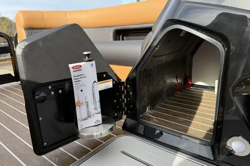 Slide: The Image of 2026 Premier 230 Sunsation boat interior with OXO paper towel holder in storage compartment. - 17