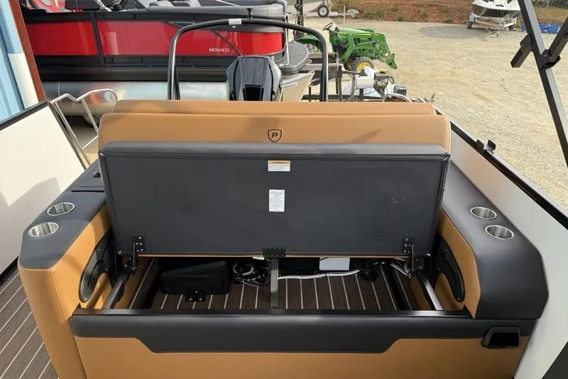Slide: The Image of 2026 Premier 230 Sunsation boat interior with tan seating and cup holders. - 23