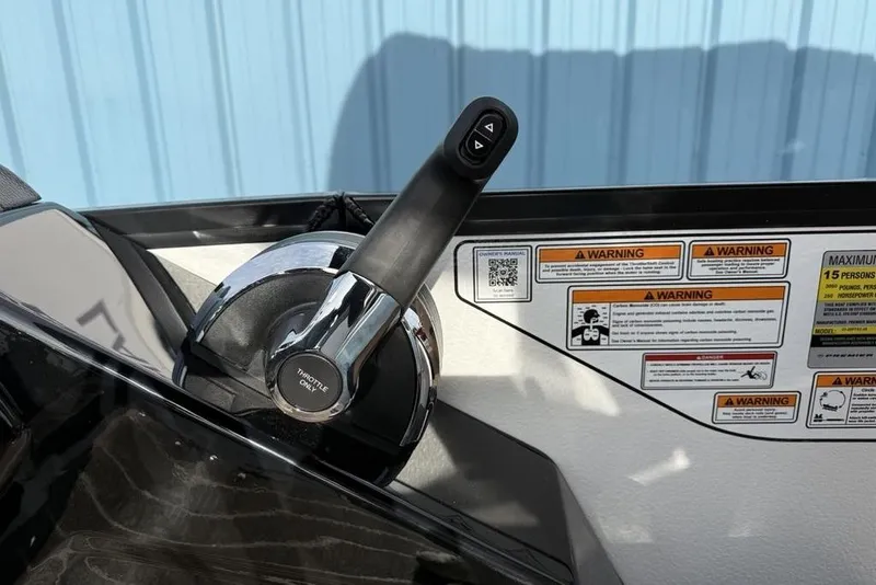 Slide: The Image of Throttle control and warning labels on 2026 Premier 230 Sunsation boat dashboard. - 25