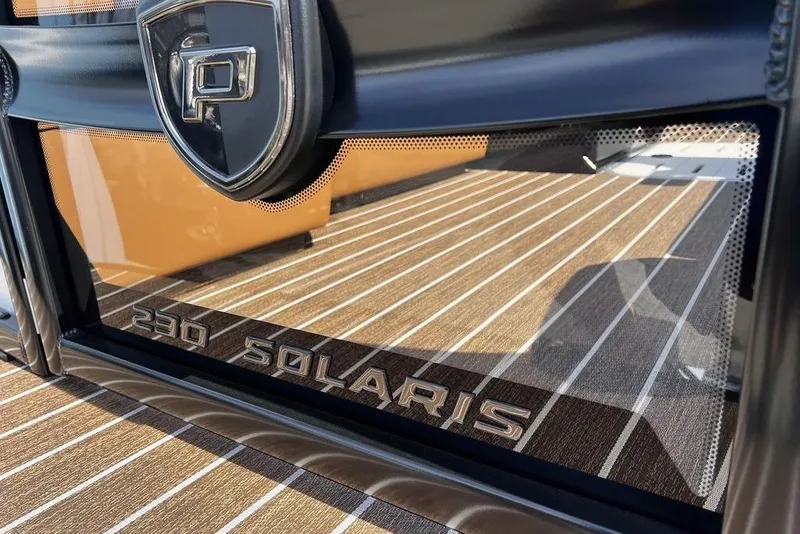 Slide: The Image of 2026 Premier 230 Solaris boat logo on sleek, striped deck surface. - 25