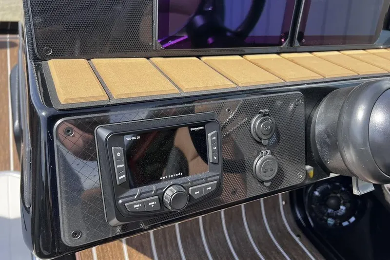 Slide: The Image of Dashboard of 2026 Premier 230 Solaris boat with audio controls and outlets. - 26