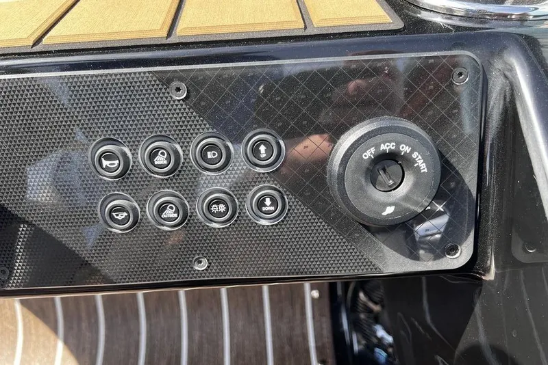 Slide: The Image of Control panel of 2026 Premier 230 Solaris boat with ignition switch and buttons. - 29