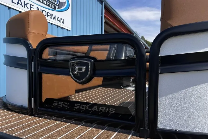 Slide: The Image of 2026 Premier 230 Solaris boat with brown seating and sleek design at Lake Norman. - 7