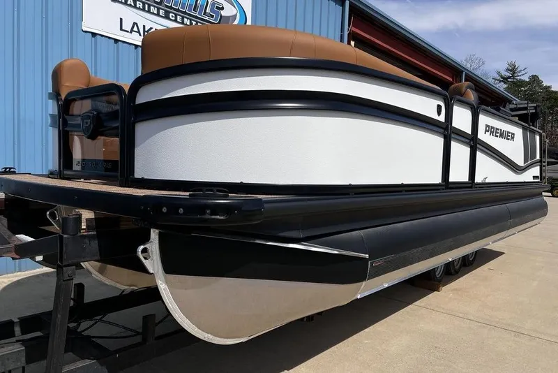 Slide: The Image of 2026 Premier 230 Solaris pontoon boat with sleek design, docked at a marine center. - 8