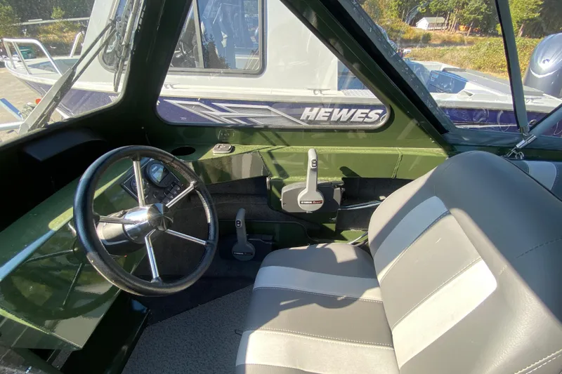 Slide: The Image of Interior of 2026 Hewescraft 200 ProV ET HT boat, featuring steering wheel and seating. - 6
