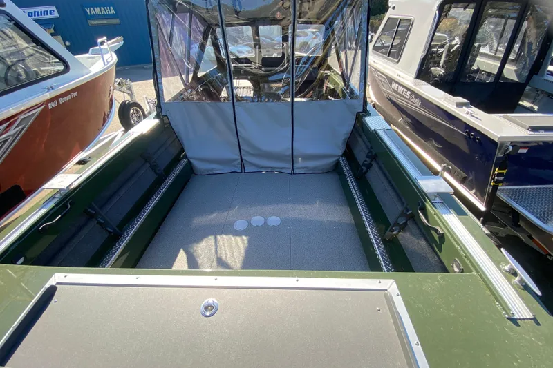 Slide: The Image of 2026 Hewescraft 200 ProV ET Hardtop boat with logo, outdoors under blue sky. - 3