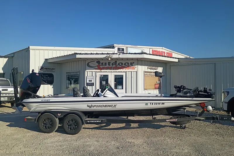 The Image of 2026 Phoenix 921 Elite X II boat parked outside Outdoor Specialties store. - 1