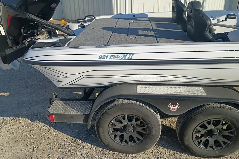 Slide: The Image of 2026 Phoenix 921 Elite X II boat on trailer, side view, showing sleek design and dual wheels. - 7