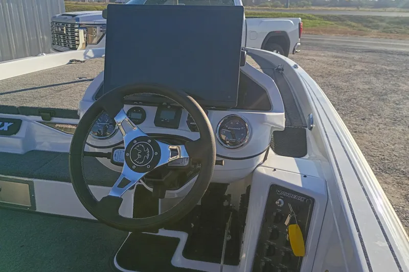 Slide: The Image of Steering console of 2026 Phoenix 921 Elite X II boat with modern controls and dashboard. - 8