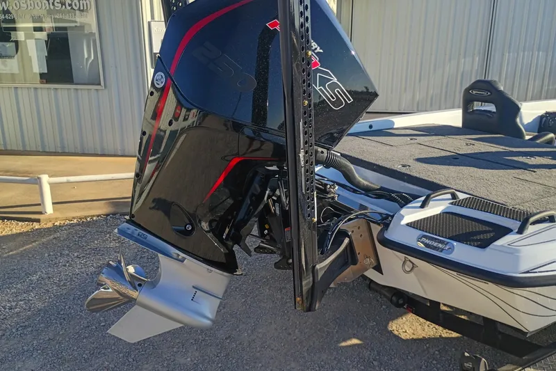 Slide: The Image of 2026 Phoenix 921 Elite X II boat with powerful outboard motor, parked outdoors. - 9