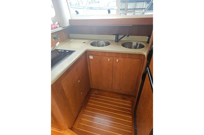 Slide: The Image of Interior of 2000 Cruisers Yachts 4450 Express Motoryacht with wooden cabinetry and countertop. - 23