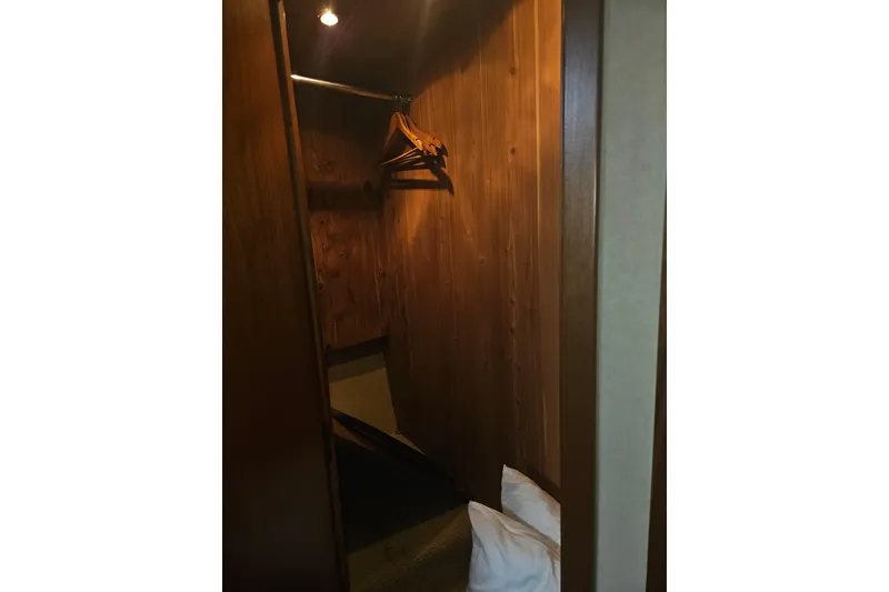 Slide: The Image of Bathroom interior of 2000 Cruisers Yachts 4450 Express Motoryacht, featuring wood cabinetry and black sink. - 52