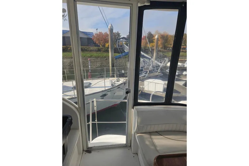 Slide: The Image of Interior view of 2000 Cruisers Yachts 4450 Express Motoryacht docked at marina. - 8