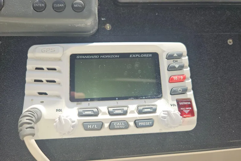 Slide: The Image of 2000 Cruisers Yachts 4450 Express Motoryacht cockpit with white seating and wooden steering wheel. - 16