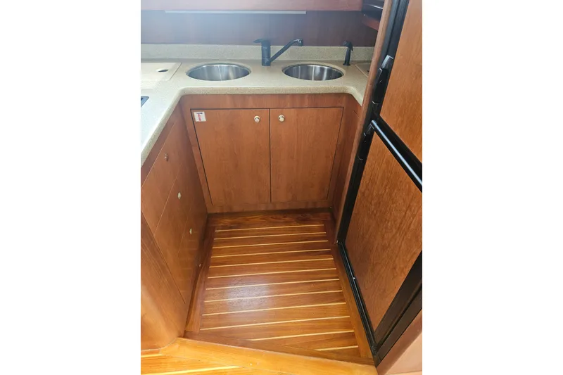 Slide: The Image of Interior of 2000 Cruisers Yachts 4450 Express Motoryacht with open wooden cabinet. - 24