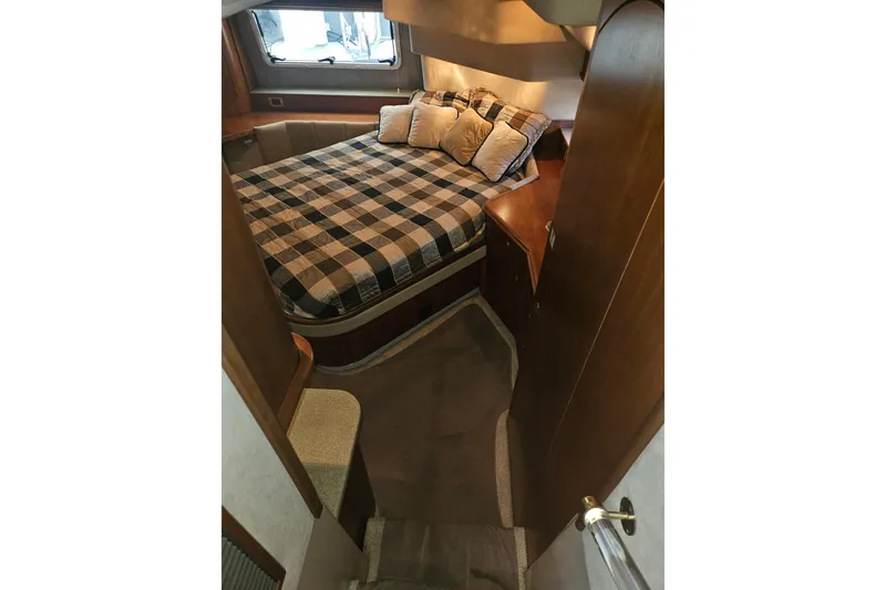 Slide: The Image of 2000 Cruisers Yachts 4450 Express Motoryacht interior with leather seating and wooden table. - 30