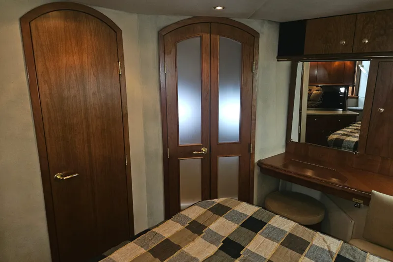 Slide: The Image of Luxurious cabin interior of 2000 Cruisers Yachts 4450 Express Motoryacht with plaid bedding. - 33