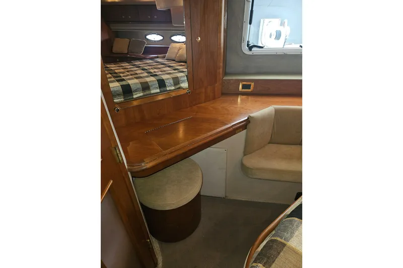 Slide: The Image of Luxurious interior of 2000 Cruisers Yachts 4450 Express Motoryacht with wood finish and cozy bedding. - 34
