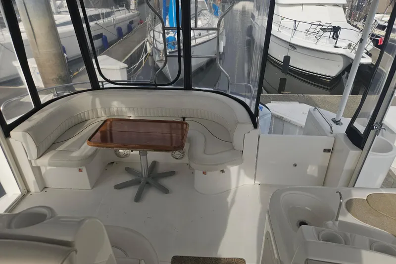 Slide: The Image of 2000 Cruisers Yachts 4450 Express Motoryacht docked, rear view with steps and cables. - 4