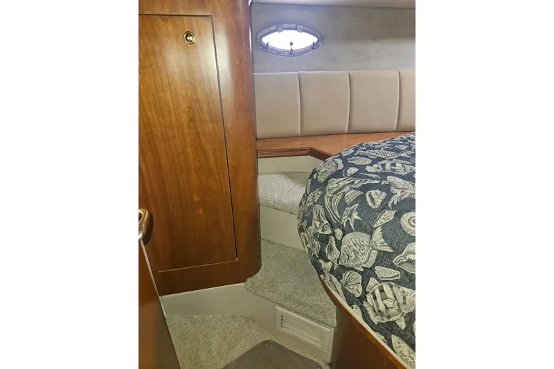 Slide: The Image of Luxury yacht bathroom with black toilet, wood cabinetry, and tiled floor, 2000 Cruisers Yachts 4450. - 45