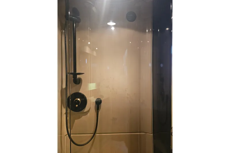 Slide: The Image of Bathroom interior of 2000 Cruisers Yachts 4450 Express Motoryacht with wooden cabinetry and black fixtures. - 51