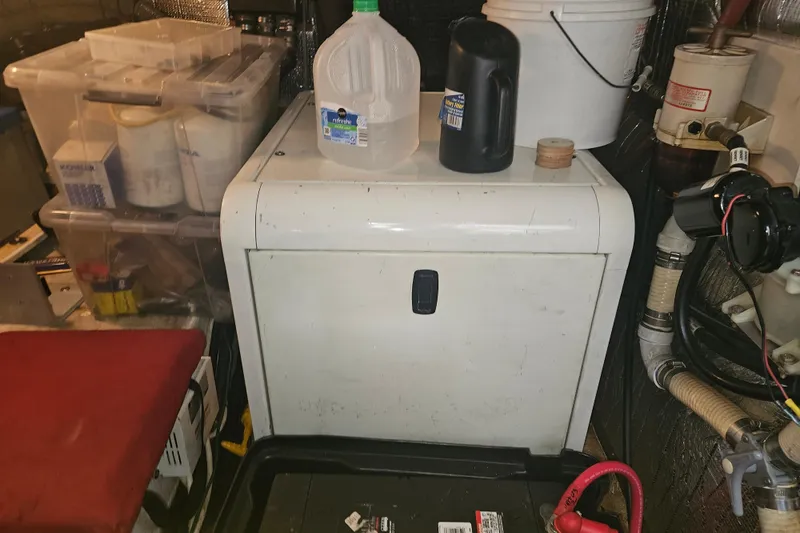 Slide: The Image of Wooden closet interior on 2000 Cruisers Yachts 4450 Express Motoryacht with hangers and pillows. - 55