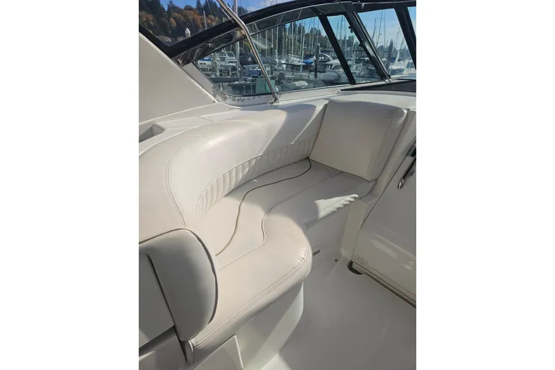 Slide: The Image of Interior view of 2000 Cruisers Yachts 4450 Express Motoryacht with seating and marina backdrop. - 9