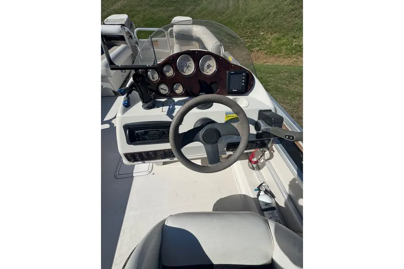 Slide: The Image of 2003 Hurricane FunDeck 226 boat dashboard with steering wheel and gauges. - 5