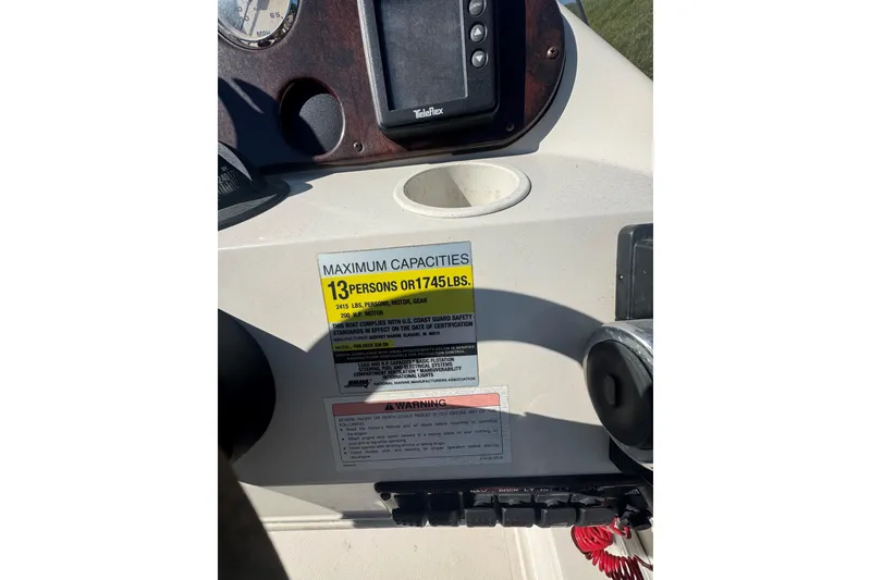 Slide: The Image of 2003 Hurricane FunDeck 226 dashboard with capacity label for 13 persons or 1745 lbs. - 6