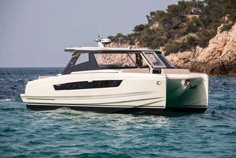 The Image of 2025 Harris-Kayot 41 boat cruising near rocky coastline. - 0