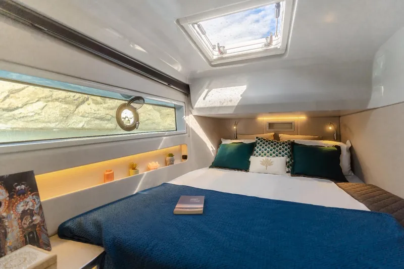 Slide: The Image of Luxurious cabin interior of 2025 Harris-Kayot 41 yacht with skylight and elegant bedding. - 13
