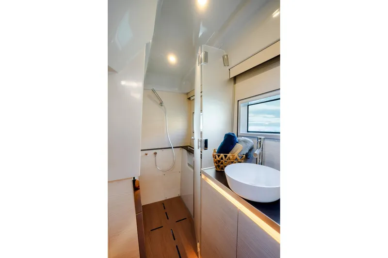 Slide: The Image of Modern bathroom interior on 2025 Harris-Kayot 41 boat, featuring sleek design and natural lighting. - 16