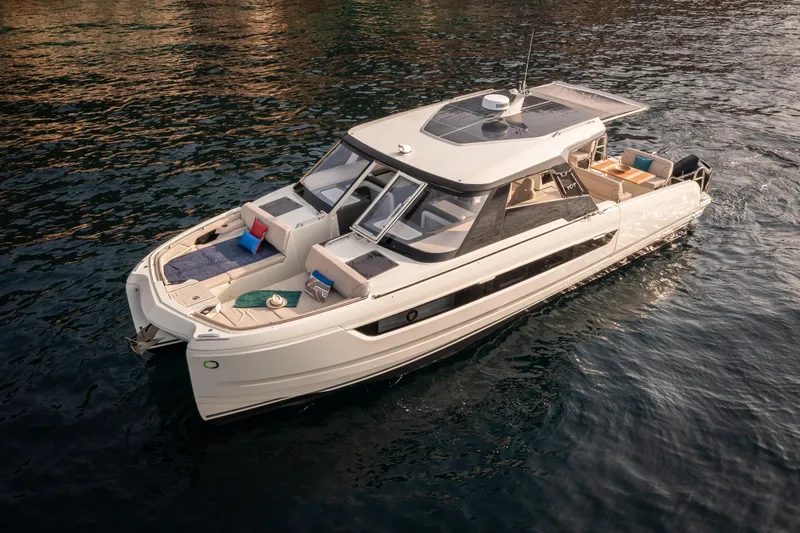 Slide: The Image of Luxury 2025 Harris-Kayot 41 yacht on serene water, featuring sleek design and spacious deck. - 3