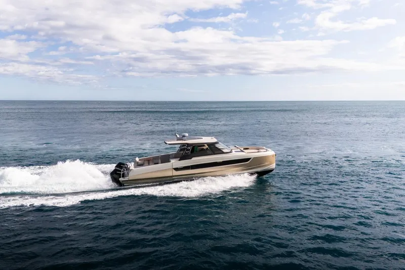 Slide: The Image of 2025 Harris-Kayot 41 boat cruising on open sea under a partly cloudy sky. - 5