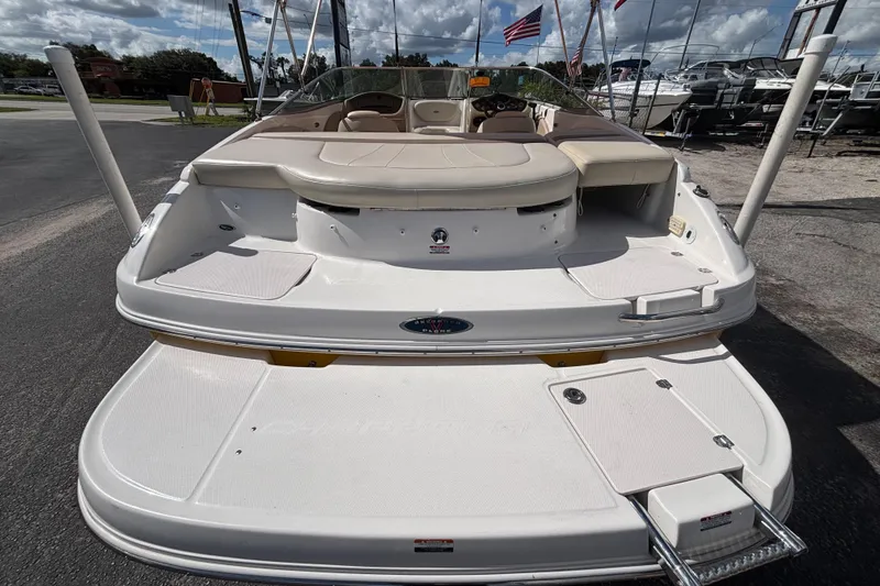 Slide: The Image of 2004 Chaparral 210 SSi boat, rear view, showcasing spacious deck and seating. - 12