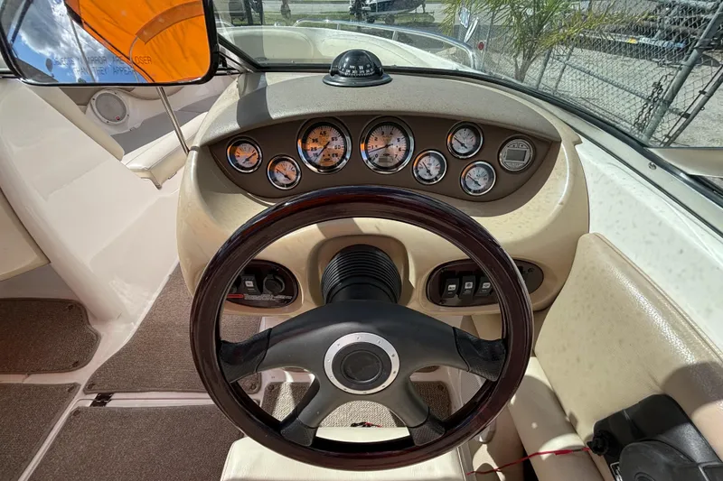 Slide: The Image of 2004 Chaparral 210 SSi boat dashboard with steering wheel and gauges. - 20