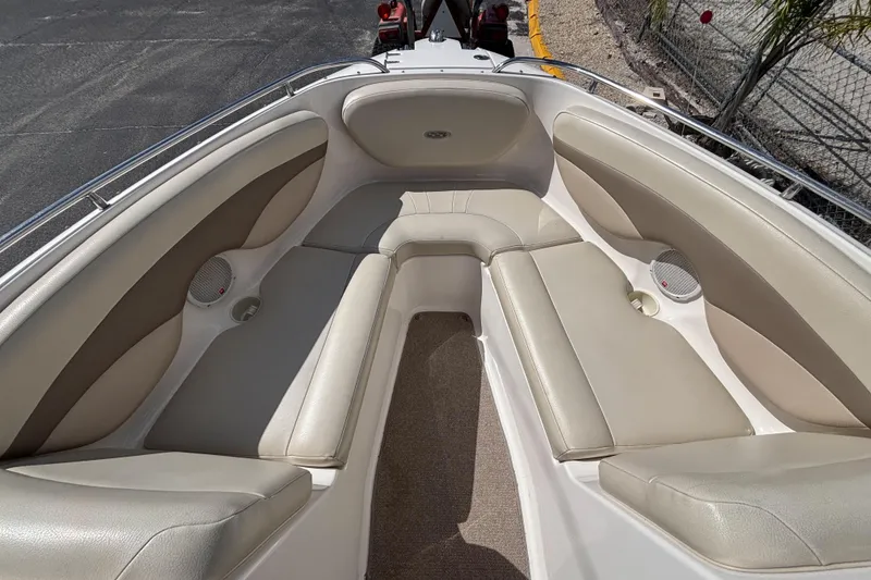 Slide: The Image of 2004 Chaparral 210 SSi boat interior with beige seating and carpeted floor. - 21