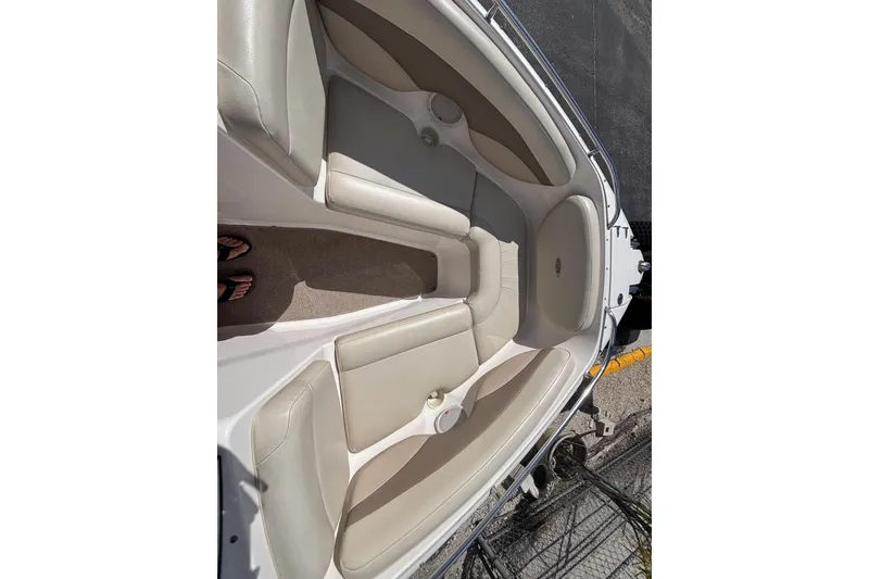 Slide: The Image of 2004 Chaparral 210 SSi boat interior with beige seating and carpeted floor. - 22