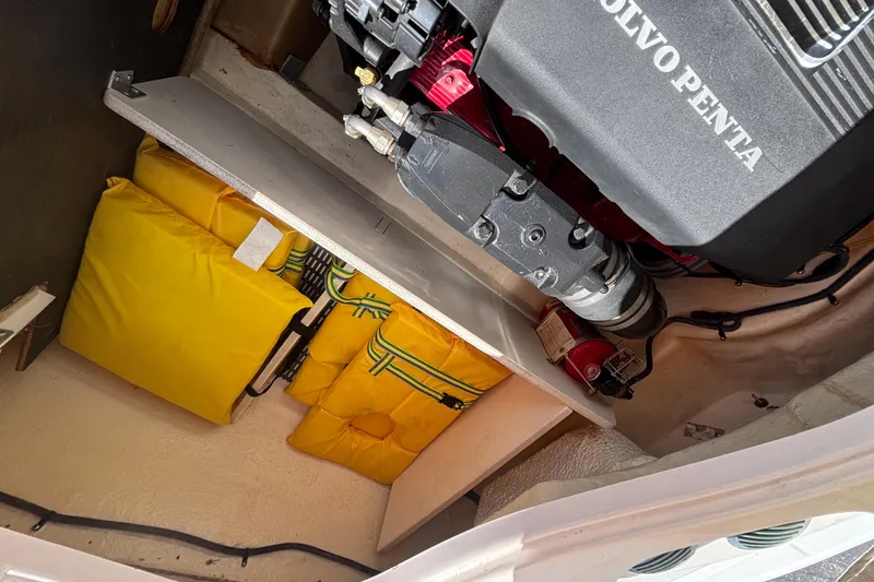 Slide: The Image of 2004 Chaparral 210 SSi boat engine compartment with Volvo Penta engine and yellow life jackets. - 28