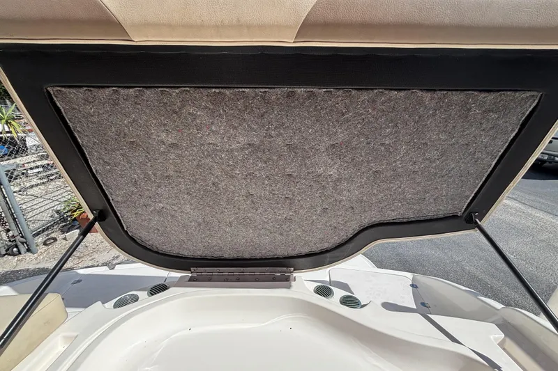 Slide: The Image of Open engine compartment of 2004 Chaparral 210 SSi boat, showing interior lining. - 31