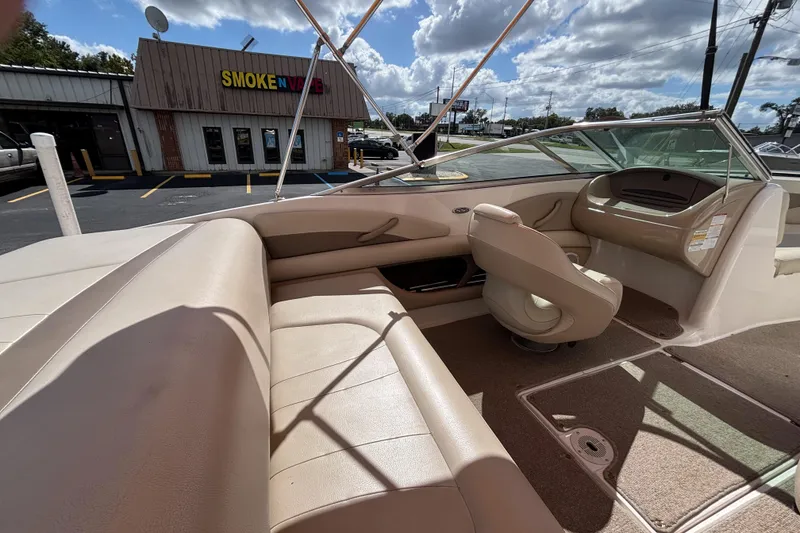 Slide: The Image of Interior of a 2004 Chaparral 210 SSi boat with beige seating and dashboard. - 34