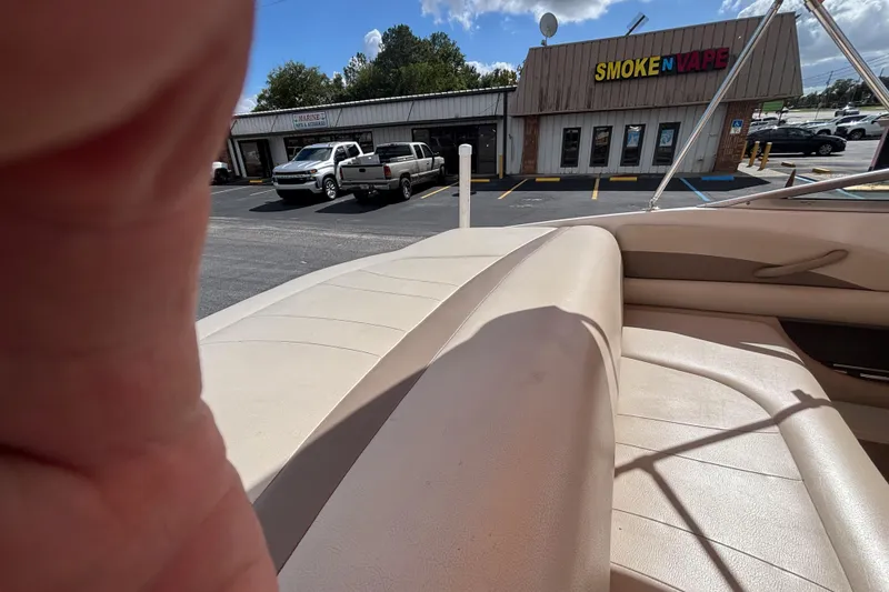 Slide: The Image of 2004 Chaparral 210 SSi boat interior with nearby parking lot and store view. - 35