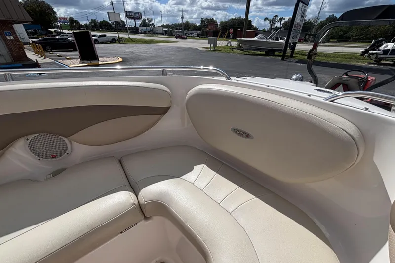 Slide: The Image of 2004 Chaparral 210 SSi boat interior with beige seating and speaker. - 37