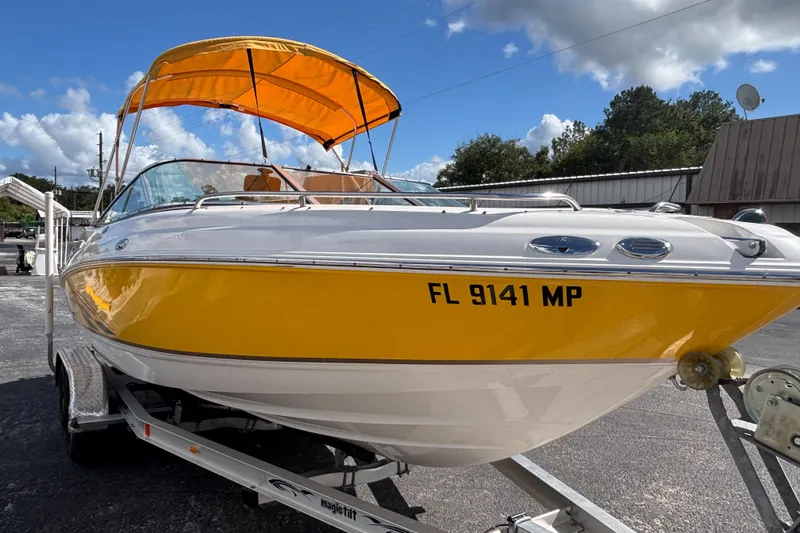 Slide: The Image of 2004 Chaparral 210 SSi boat with yellow hull and canopy on a trailer. - 6